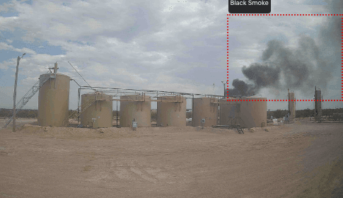 A photo of Fire Detection service illustrateed on the example of smoke coming from behind an oil tank, with annotations.
